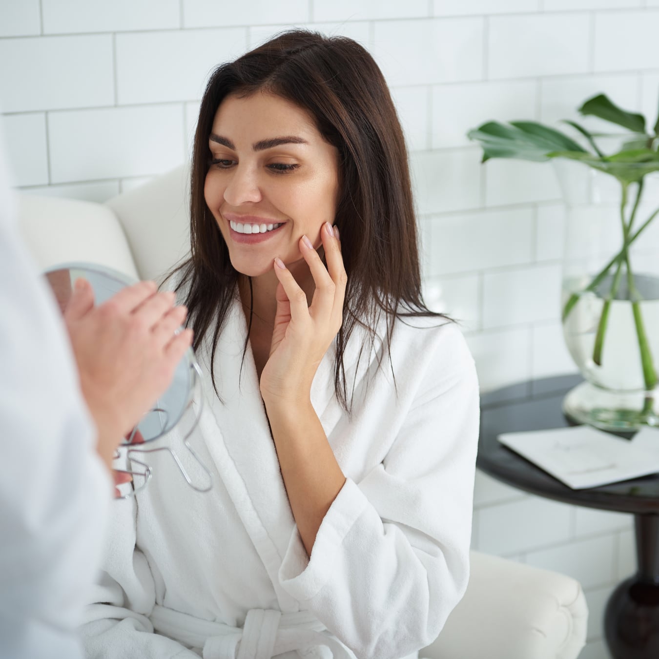 Woman discussing her skin with an aesthetic practitioner during a consultation