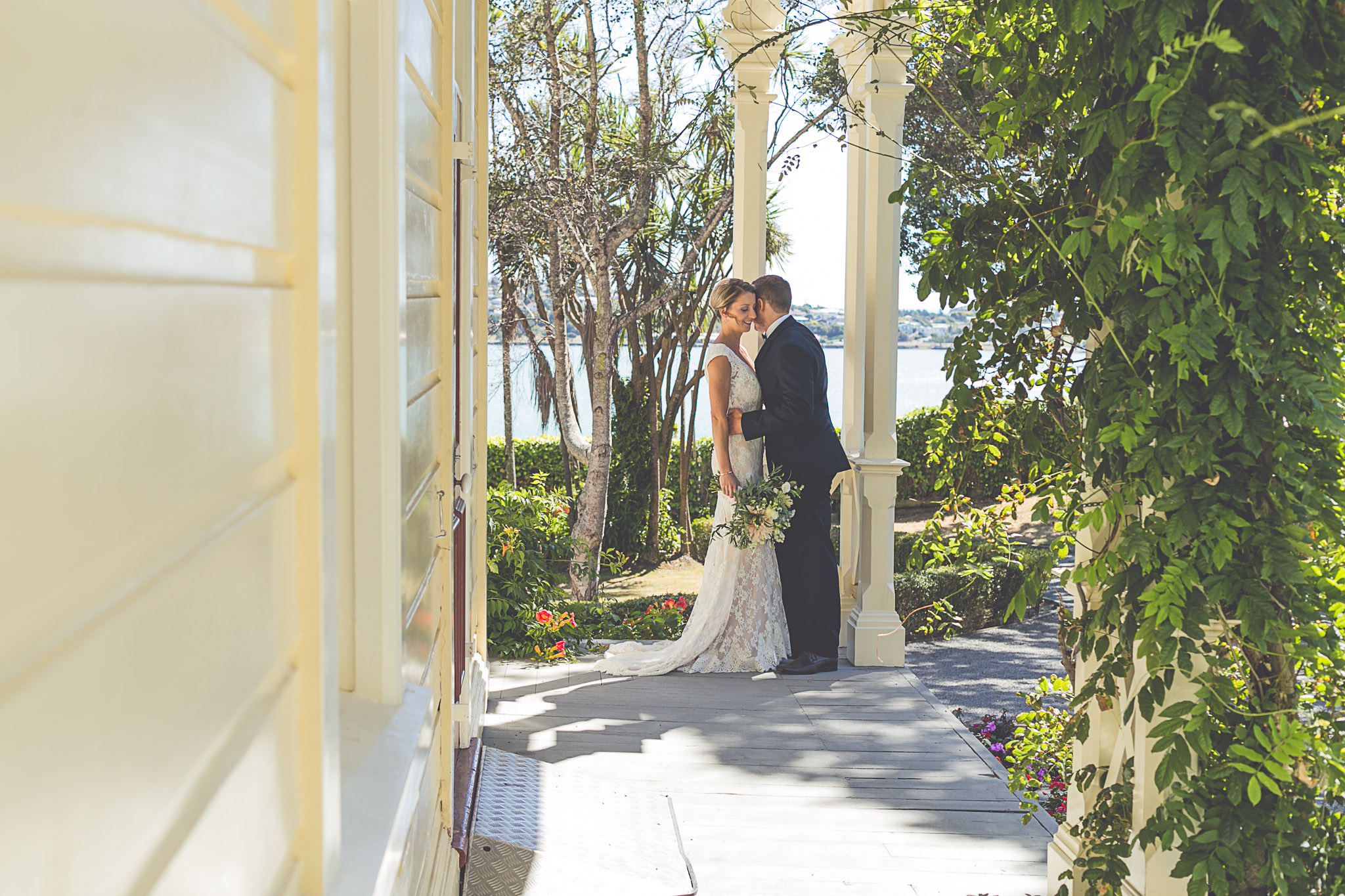 Bride and groom standing together outdoors on their wedding day