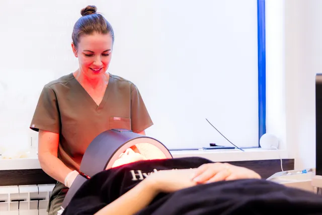Skin specialist medical aesthetician overseeing an LED light therapy MediFacial
