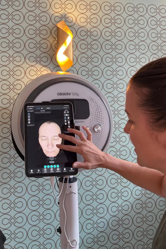 Practitioner reviewing Observ 520x skin analysis results on screen